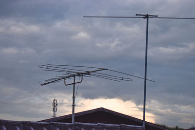 Low angle view of communications tower against sky during sunset