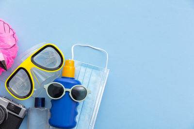 Low angle view of sunglasses against blue sky