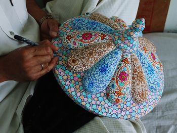 Kashmiri artisan making products of paper mache