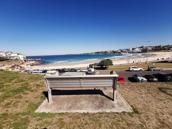 Scenic view of beach against clear blue sky