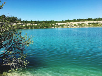 Scenic view of lake against clear blue sky