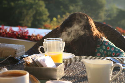 Close-up of coffee cup and juice glass on table