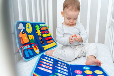 Portrait of boy playing with toy blocks at home