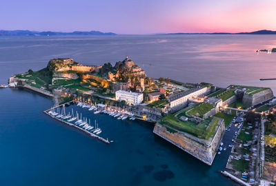 Aerial view of buildings on island during sunset