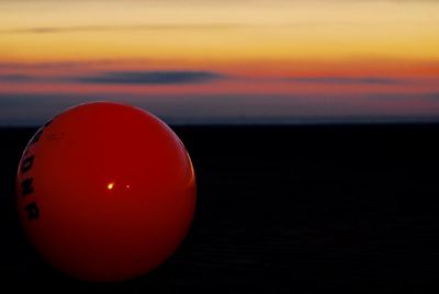 Close-up of ball against sunset