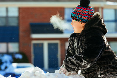 Boy in warm clothing looking away