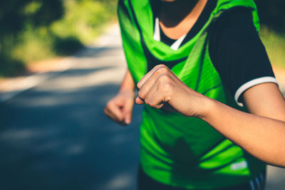 Midsection of man running on green leaf