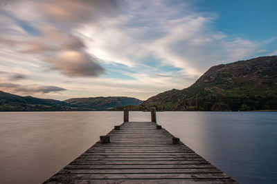 Pier over lake against sky