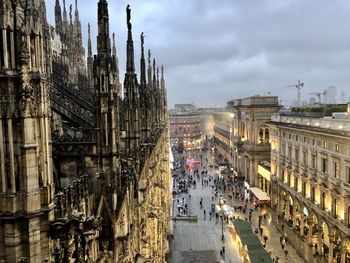 Rooftop view from the illuminated duomo di milano during the christmas holidays in milan, italy.