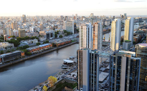 High angle view of river amidst buildings against sky