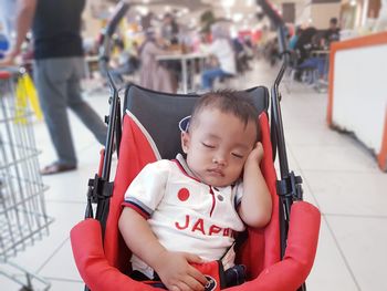 Cute boys sleeping in baby stroller