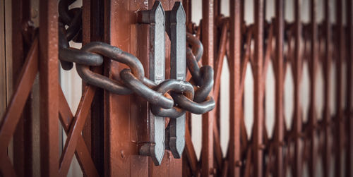 Close-up of rusty metal chain on gate