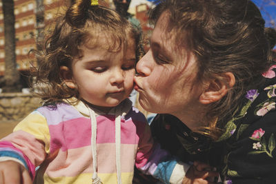 Close-up of mother and daughter at home