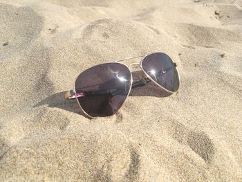 High angle view of sunglasses on beach