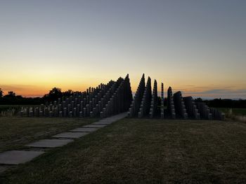 Scenic view of field against clear sky during sunset