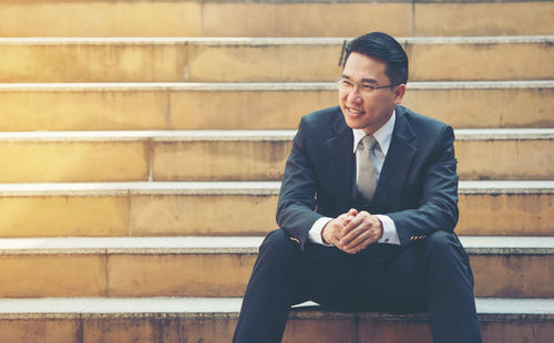 Businessman sitting on steps