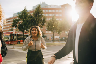 Happy woman on street in city