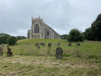 Panoramic view of church on field against sky