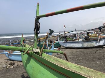 Boats moored on beach