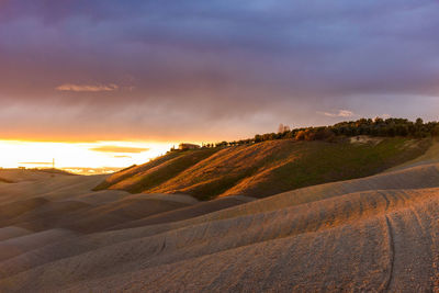 View of sand dunes at sunset