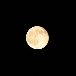 Low angle view of full moon against clear sky at night