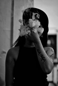 Portrait of woman holding flower