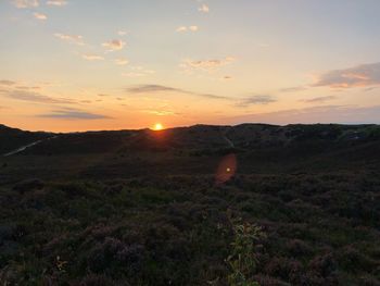 Scenic view of field against sky during sunset