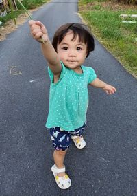 Portrait of cute girl walking on road