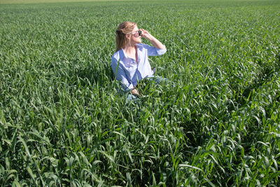 Rear view of boy standing on grassy field