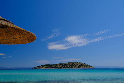 Panoramic view of sea against blue sky