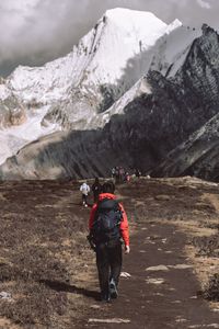 Rear view of man walking on mountain