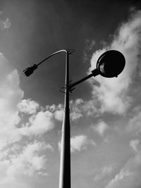 Low angle view of street light against cloudy sky