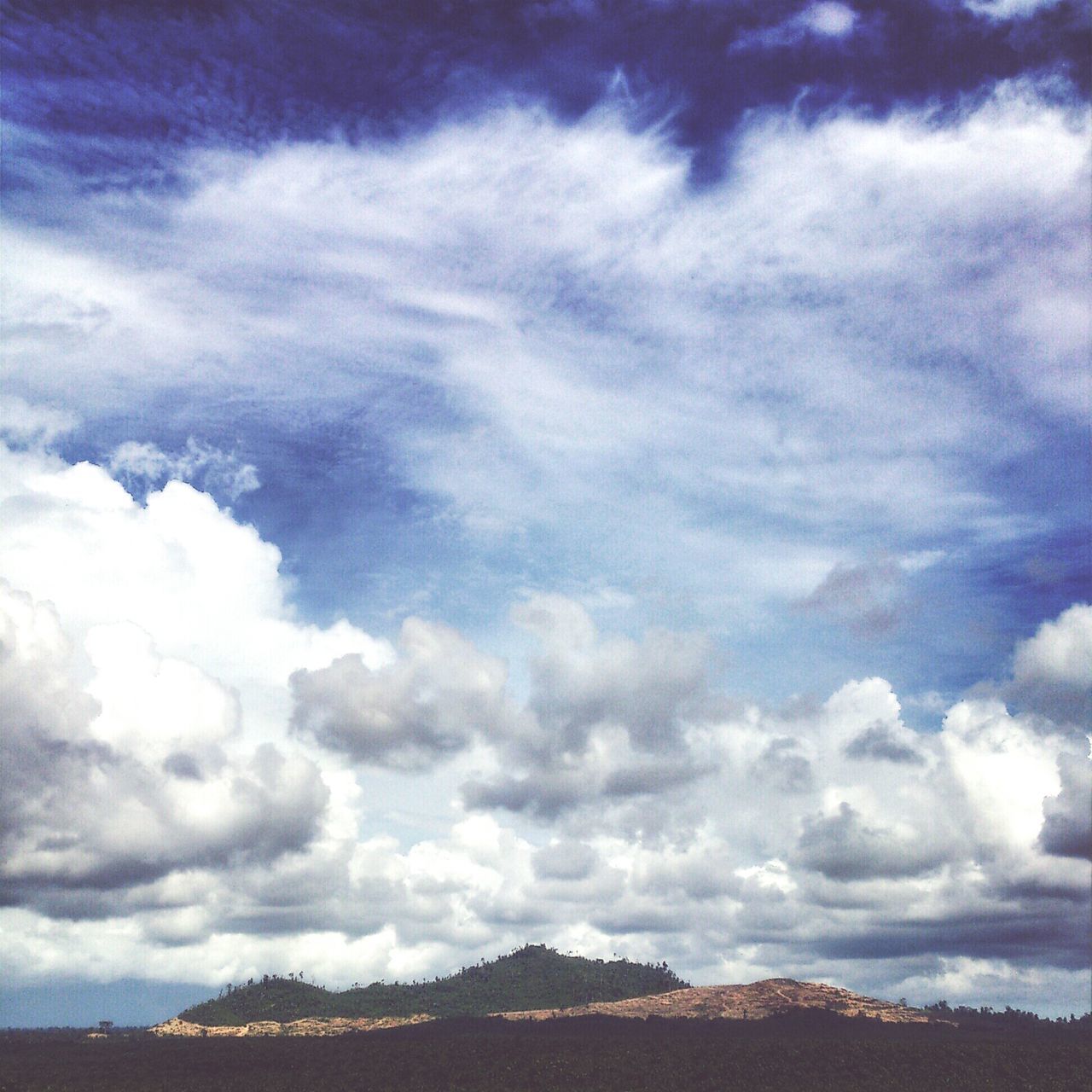 sky, cloud - sky, cloudy, scenics, tranquil scene, tranquility, beauty in nature, cloud, landscape, nature, weather, mountain, cloudscape, low angle view, idyllic, blue, non-urban scene, overcast, outdoors, day