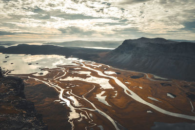 Aerial view of landscape against cloudy sky