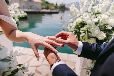 Midsection of couple holding hands