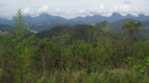 Scenic view of green mountains against sky