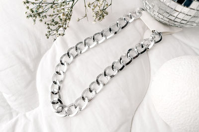 High angle view of necklace on bed