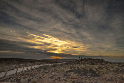 Scenic view of land against sky during sunset