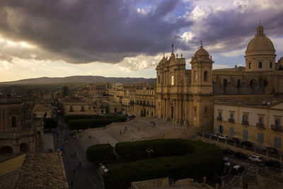 High angle view of buildings in city against cloudy sky in noto sicily