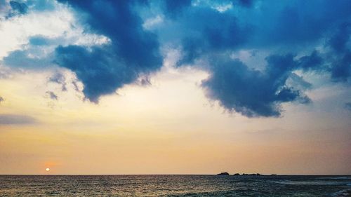 Scenic view of sea against sky at sunset