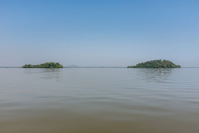 Scenic view of sea against clear blue sky