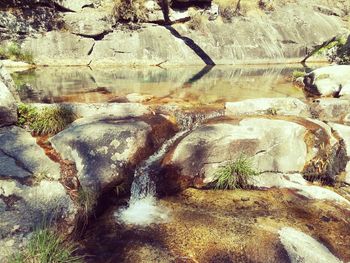 High angle view of rocks by lake