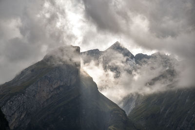 Low angle view of mountain range against sky