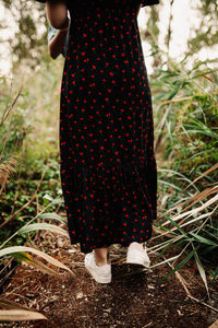 Rear view of woman walking in forest