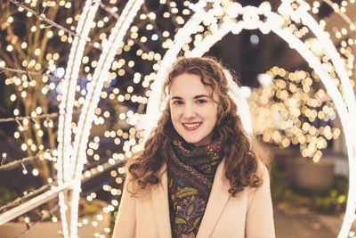 Girl outdoors, christmas lights in the background