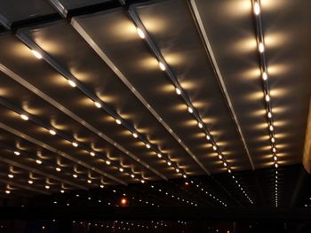 Low angle view of illuminated lights at night