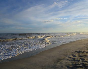 Scenic view of beach against sky during sunset