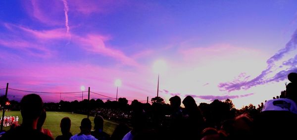 People in amusement park at sunset