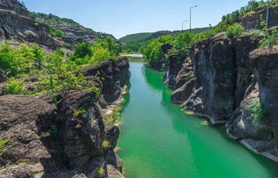 Scenic view of waterfall against sky