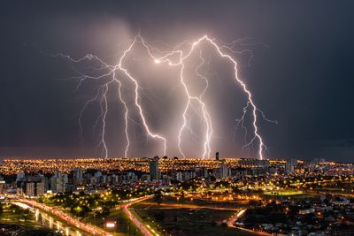 Panoramic shot of illuminated city against sky at night